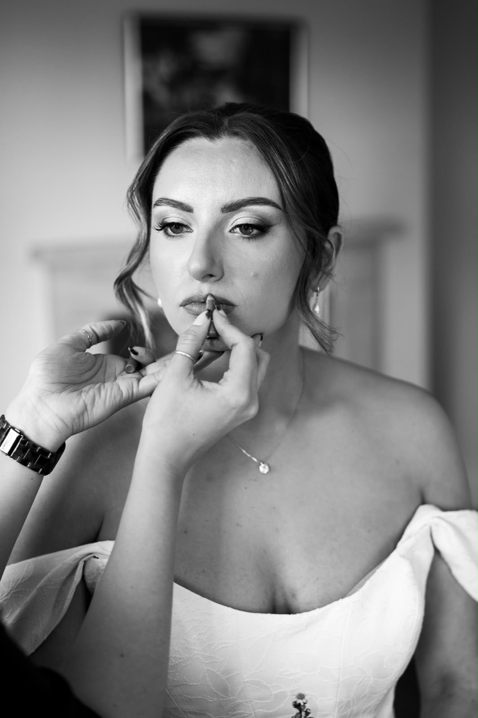 Charly-Ann applying lip colour to a bride