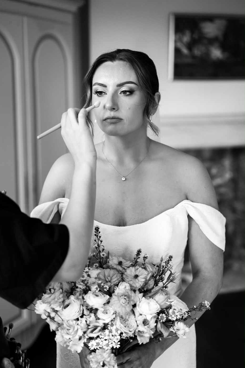 Black and white close-up of eye makeup being applied