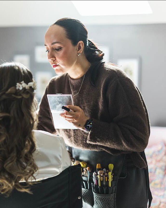 Charly-Ann doing a bride's makeup on her wedding morning