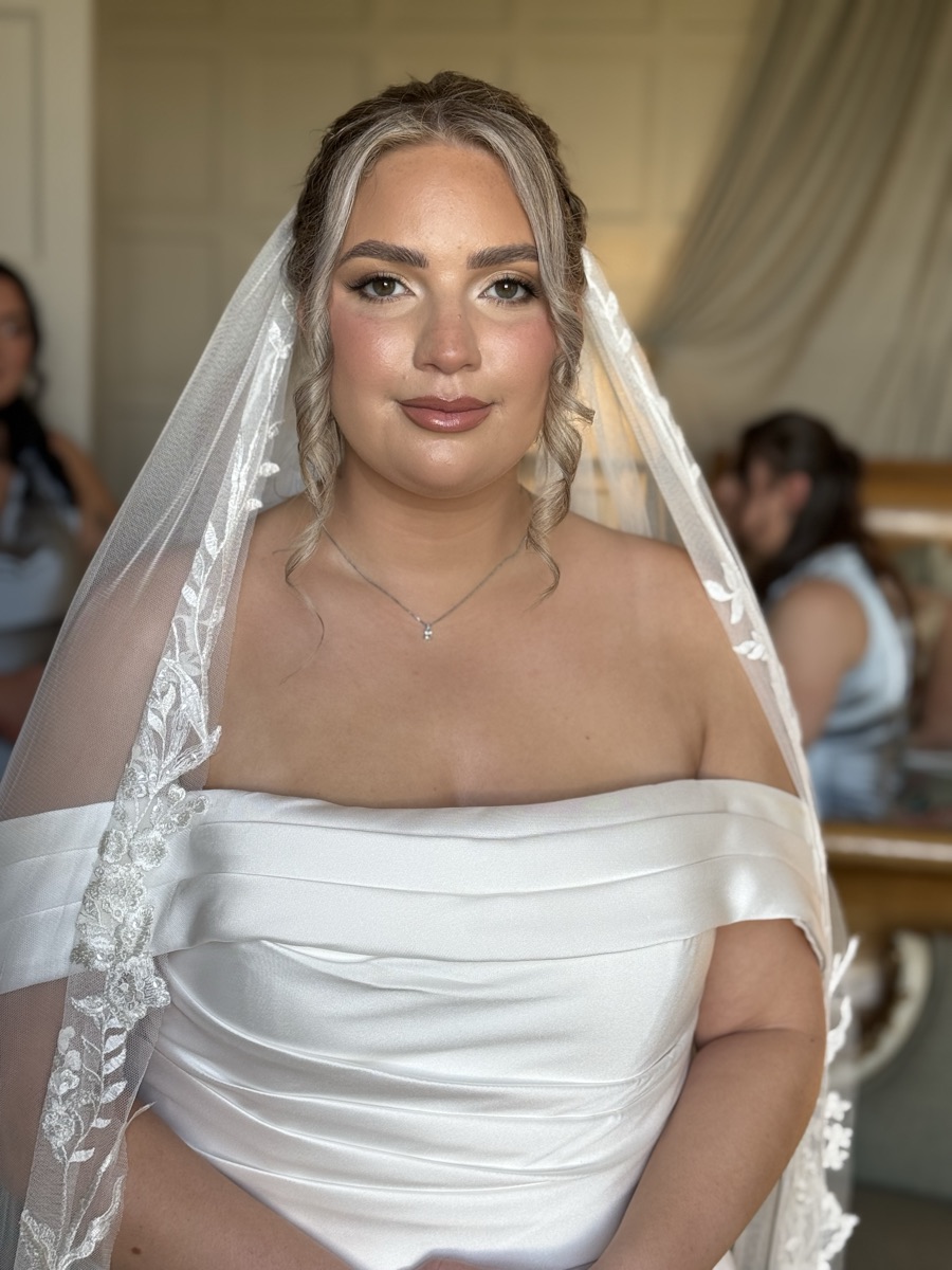 Bride with soft bronzed makeup and lace veil