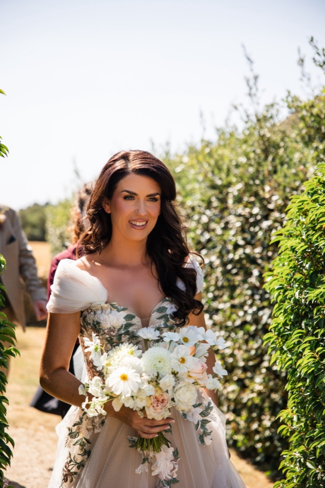 Bride with soft glam and long waves outdoors