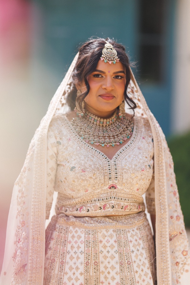 Bride in embellished lehenga with bold bridal makeup