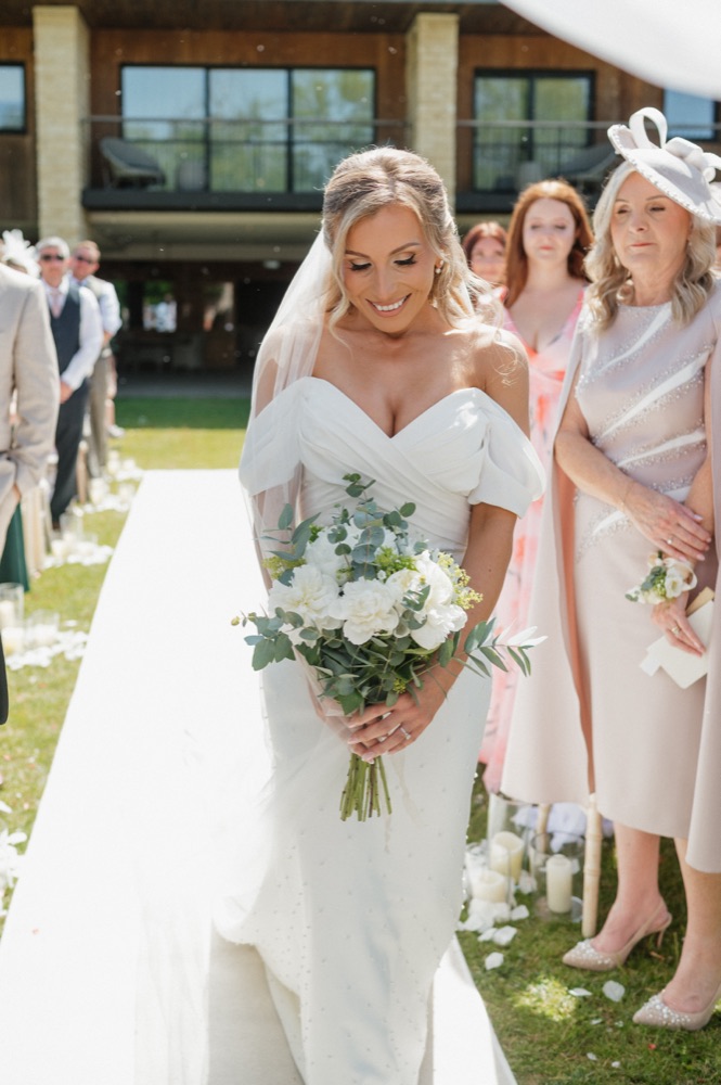 Bride walking down the aisle with bouquet