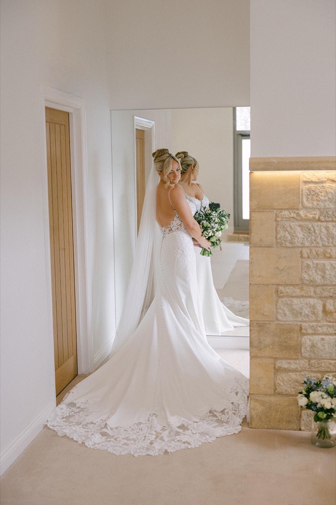 Bride checking her dress in the mirror