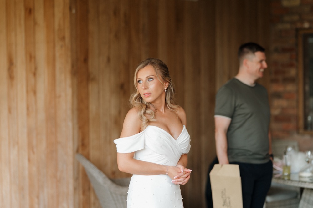 Bride in an off-shoulder dress on her wedding morning